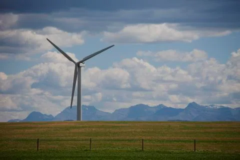 Wind generators in field, mountain range in background, Montana, USA Stock Photos