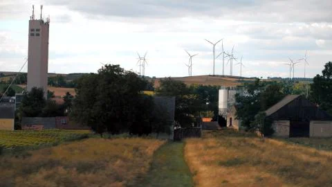 Wind generators, fields and village in Austria as seen from the car Stock Photos
