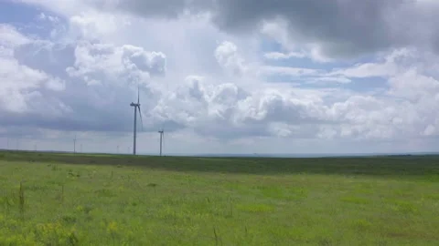 Wind generators in a green field. Renewable energy source, earth care. Stock Footage 169960380