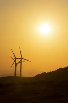 Wind generators in the mountains at sunset Stock Photos