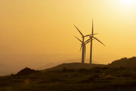 Wind generators in the mountains at sunset Stock Photos