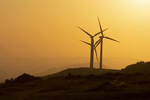 Wind generators in the mountains at sunset Stock Photos