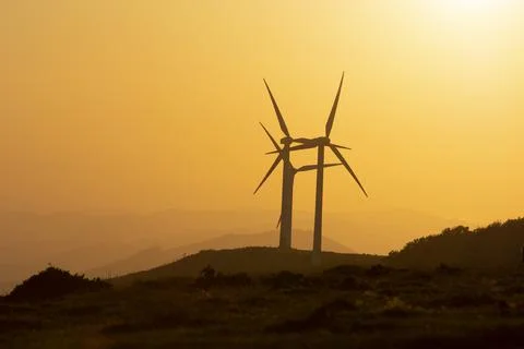 Wind generators in the mountains at sunset Stock Photos
