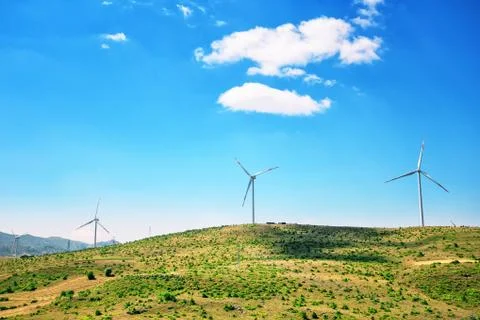 Wind generators on a plain under a blue sky Stock Photos