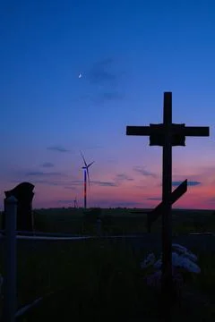 Wind generators view from cemetery in evening time Stock Photos