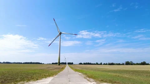 Wind generators in a wheat field against a blue sky, renewable energy sources Stock Footage 204912512