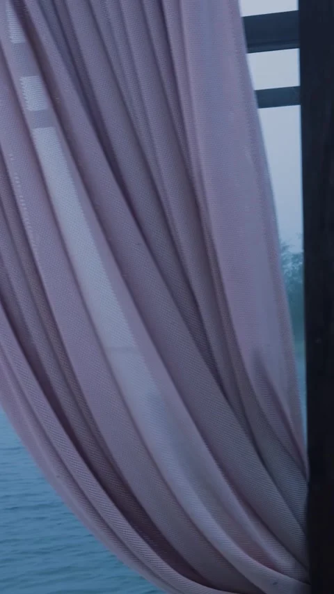 Wind gently blowing curtains over misty lake Stock Footage 288242861
