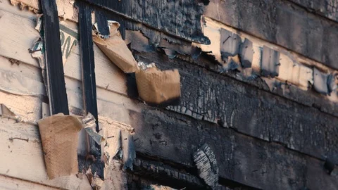 Wind gently blows on charred remains of facade of house burnt down by fire. Stock Footage 101393941