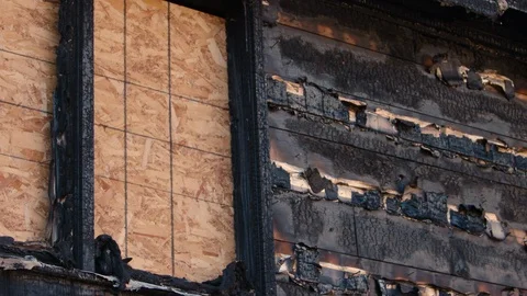 Wind gently blows on charred remains of wooden house destroyed by fire 스톡 동영상 101393949