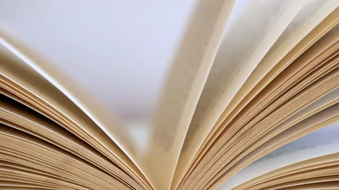 Wind gently moves the yellow opened book pages Stock Footage 136577116