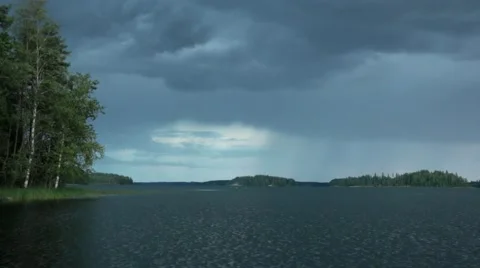 Wind growing stronger as rain clouds approach behind a lake Stock Footage 54506981