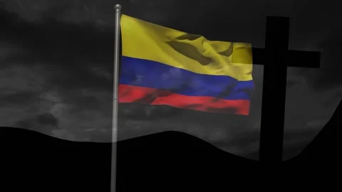 Wind gusts causing Colombian flag unfurling on pole beside cross silhouette Stock Footage 328252252