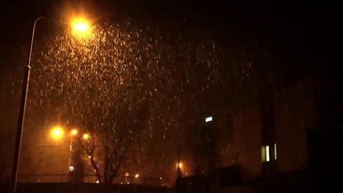 Wind gusts make waves in thick snowfall, illuminated by street lamp light. Stock Footage 134911025