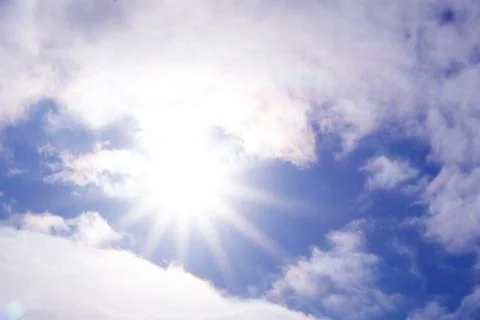The wind hardly pushes the clouds across the sky , visible rays of the sun Stock Photos