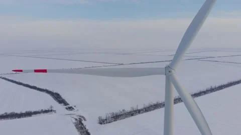 Wind machine turns against fields covered with white snow Video stock 149011834