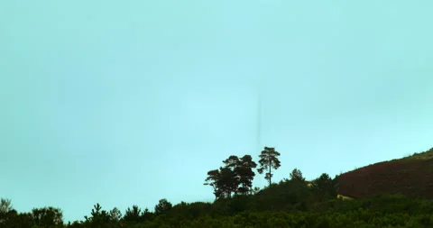 Wind machines producing alternative energy in foggy morning. Turbines rotating Stock Footage 221849567