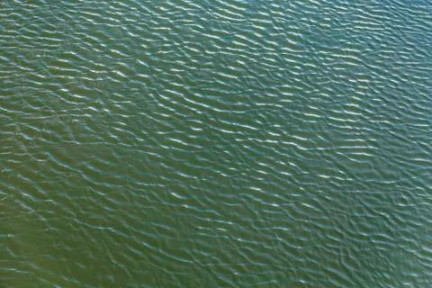 Wind makes a harmonic wave pattern on the river 스톡 사진