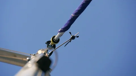 Wind meter and direction pointer called windex at top of main mast of boat. Stock Footage 90658811
