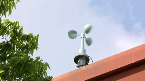 Wind meter spinning against blue sky Stock Footage 39679556