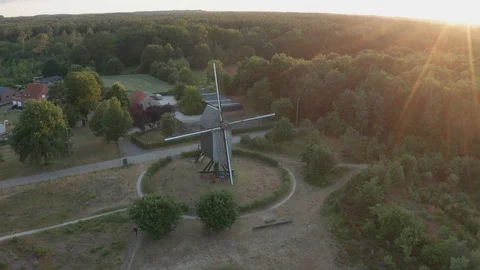 A wind mill machine converting energy of wind in rotational energy by blades sun Stock Footage 123090315