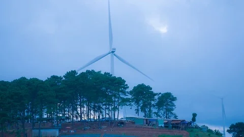 Wind mill or also wind-turbine on wind farm in rotation Stock Footage 90782814