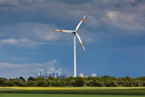 Wind mill with power plant in background Stock Photos