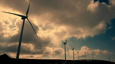 Wind mill turbines blades rotating generating power sunset clouds Stock Footage 47009679