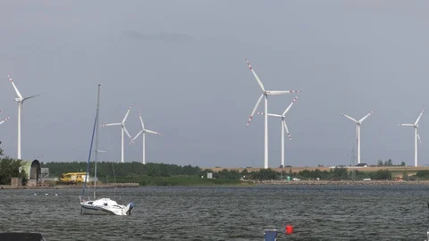 Wind mill turbines installed along shore at clear day Stock Footage 122988299