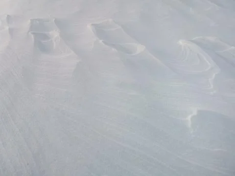 Wind patterns on snow crust for white winter background Stock Photos