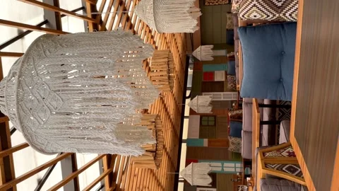 The wind plays with a floor lamp in an empty cafe in an open veranda Stock Footage 247776127