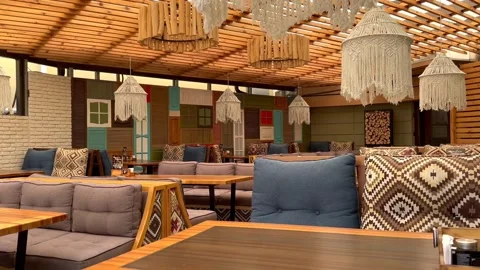 The wind plays with a floor lamp in an empty cafe in an open veranda Video stock 247776136