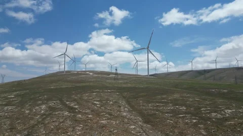 Wind power energy - electricity production - Power lines transmission lines - 4K Stock Footage 336190822