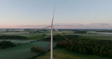 Wind power generating plant early in the morning windmill at sunrise Stock Footage 256864220