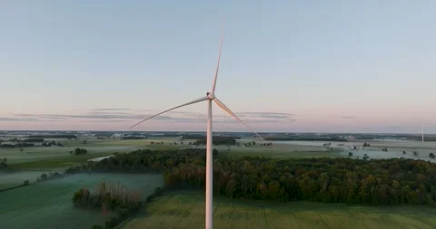 Wind power generating plant early in the morning windmill at sunrise Stock Footage 256864287