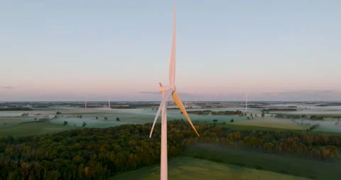 Wind power generating plant early in the morning windmill at sunrise Stock Footage 256864655