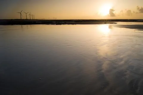 Wind power generator under sunset Fotos de archivo