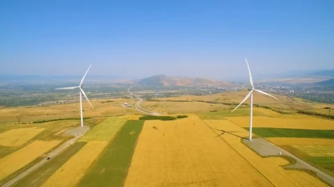 Wind power generators and yellow field drone view 스톡 동영상 94536045