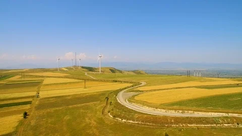 Wind power generators and yellow field aerial around panorama 스톡 동영상 94536231