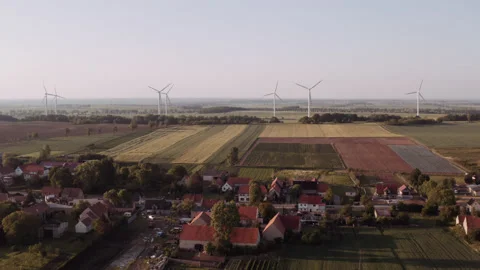 Wind power generators behind a small village. Stock Footage 149111708