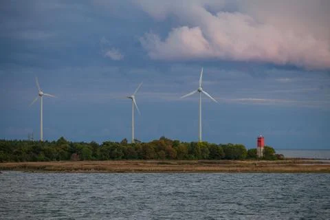 Wind power generators on the coast of Baltic sea. Summer cloudy wheather. Stock Photos