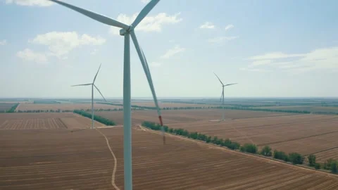 Wind power generators in the field on the coastline Stock Footage 255622315