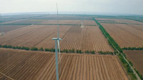 Wind power generators in the field Stock Footage 255622097