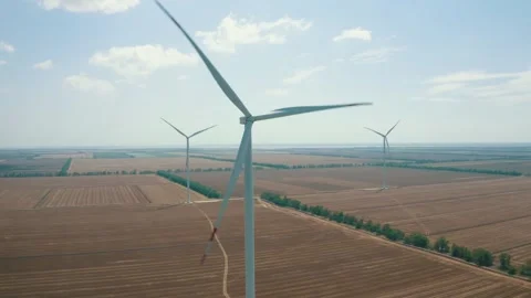 Wind power generators in the field Stock Footage 255622351
