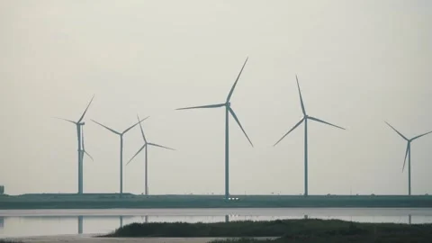 Wind power generators in the field Stockbeeldmateriaal 255622634