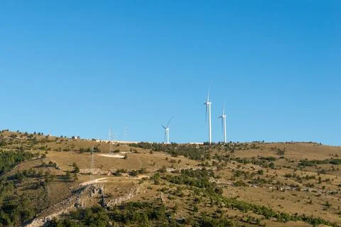 Wind power generators installed on hilly terrain, sustainable electricity p.. 스톡 사진
