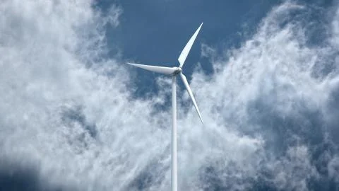 Wind power generators on sky background. Ilustración de archivo