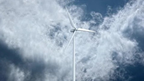 Wind power generators on sky background. Ilustración de archivo