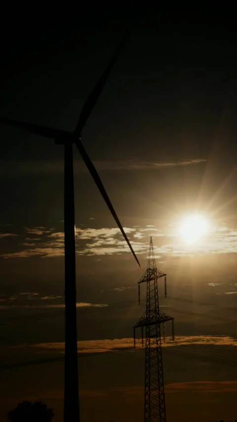 Wind power plant, high-voltage mast, sun, clouds, partial solar eclipse, Stock Footage 342187787