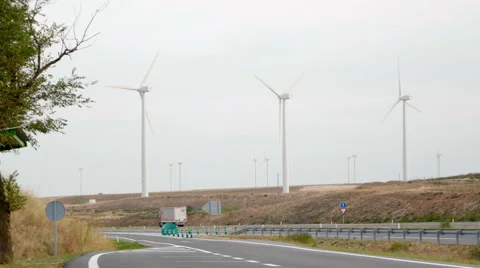 Wind power plant on the highway Stock Footage 58628107