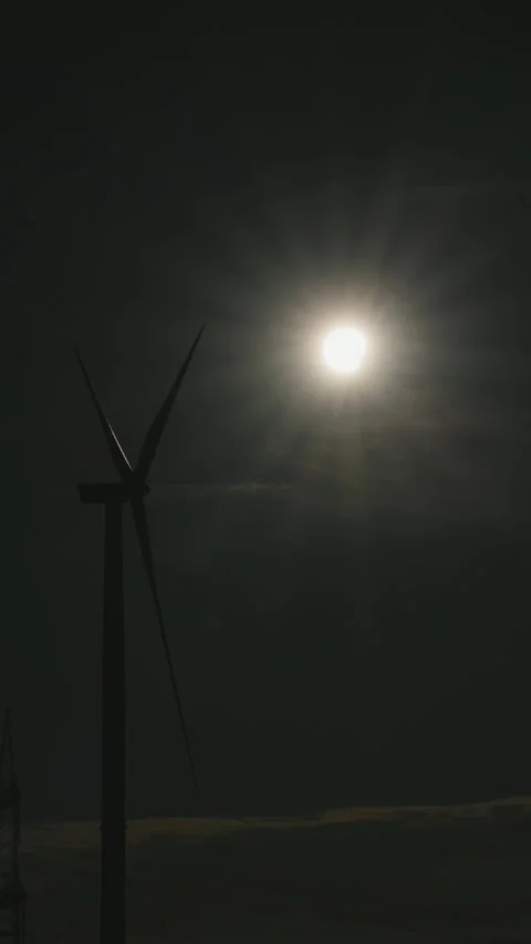 Wind power plant, sun, beginning partial solar eclipse, Melbeck, Samtgemeinde Stock Footage 342188496